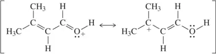 Two resonance structures of a molecule with arrow-pushing formalism indicating electron flow between them.