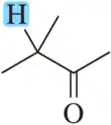 Molecule with a blue-highlighted hydrogen on a methyl group adjacent to a carbonyl, illustrating NMR spin-splitting.